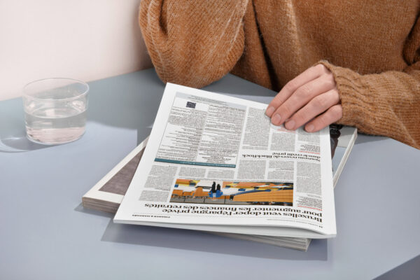 Lecture d'un journal d'annonces légales sur table de travail